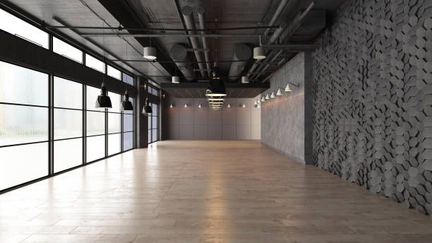 istock Large open empty space with concrete wall illuminated by natural light from windows 1181233275