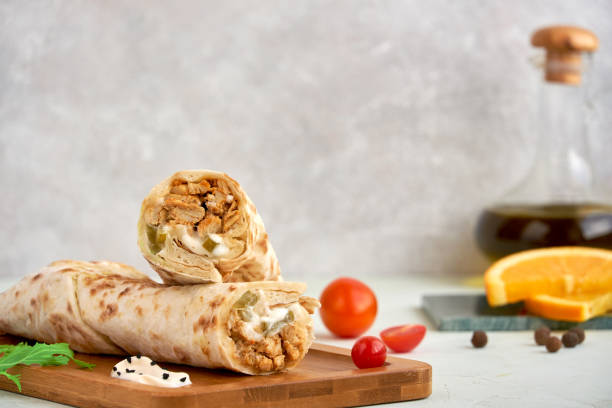 istock Shawarma with chicken on wooden board, closeup with space for text 1181234393