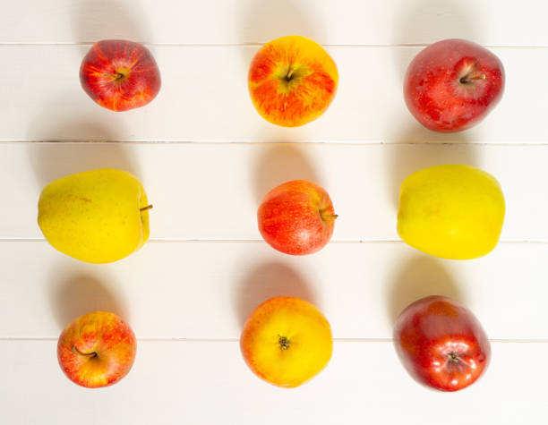 istock Red and yellow apples on a white background. 1181236089