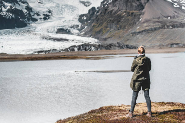 istock Woman, lake and glacier 1181236942