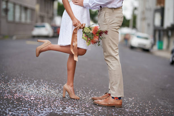 The married life is worth living Cropped shot of a newly married young couple celebrating their wedding day against an urban background eloping stock pictures, royalty-free photos & images