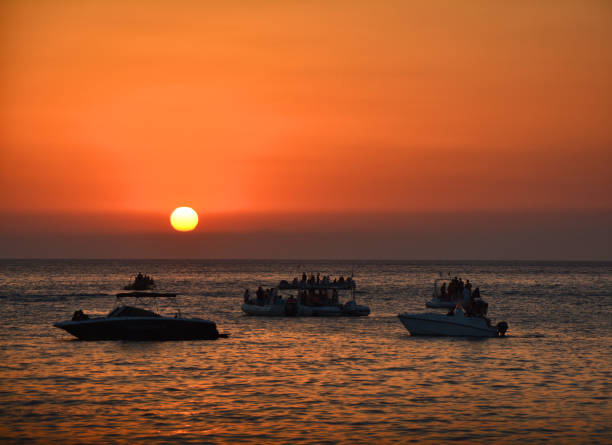 istock People watching sunset from boats 1181238419