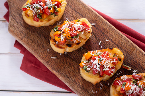 Fresh bruschetta with tomatoes, olive oil, basil, parmesan cheese and balsamic vinegar.