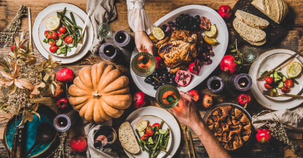 istock People clinking glasses and celebrating Thanksgiving day, top view 1181240574