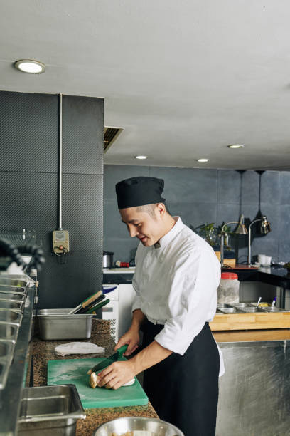 istock Asian cook cutting the vegetable 1181240590