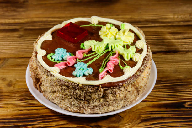 istock Kiev cake with cream, nuts and meringue on wooden table 1181240916