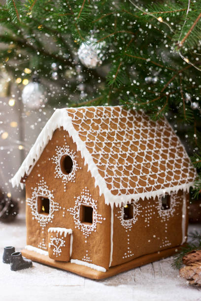 istock Gingerbread house and Christmas trees on a luminous background. Bokeh effect. 1181241691