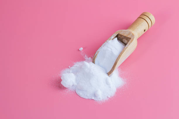 istock baking soda in old wooden spoon on pink background 1181242066