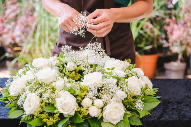 istock Gardener woman creating grave decoration 1181245965