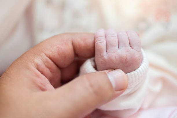 istock Baby Holding Mothers Hand 1181248213