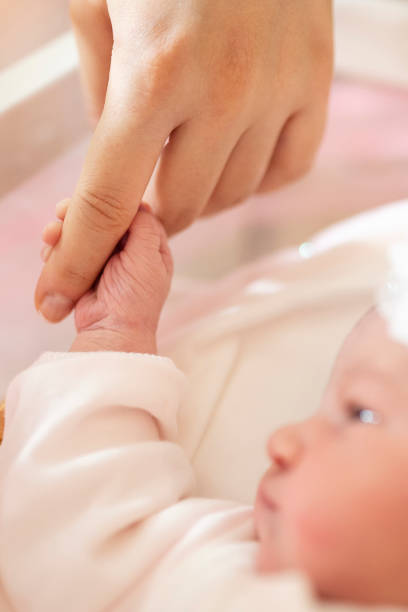 istock Baby Holding Mothers Hand 1181248239