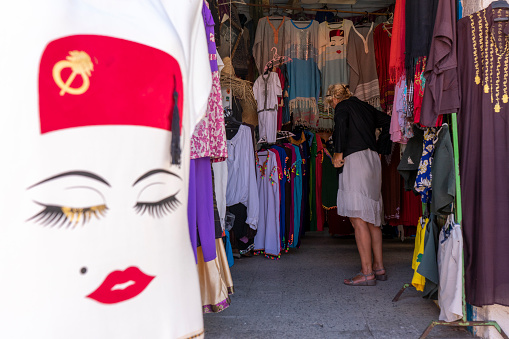 Tunisia. (Southern Tunisia). Island of Djerba. Houmt Souk. June 29, 2019. Tourist buying clothes in the souks