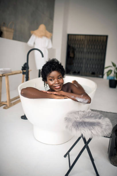 istock Beaming dark-skinned woman having rest in bath at the weekend 1181251357