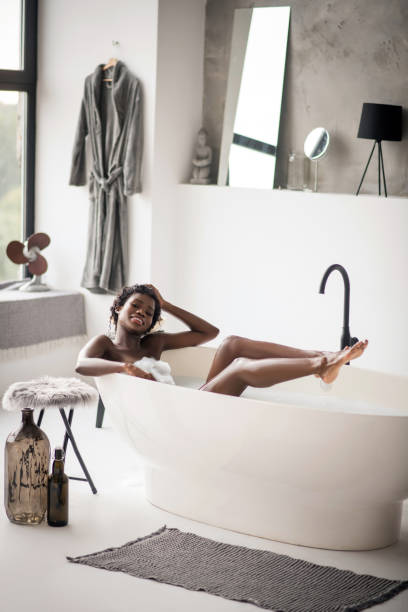 istock Woman chilling in bath in spacious bathroom with modern interior 1181251434