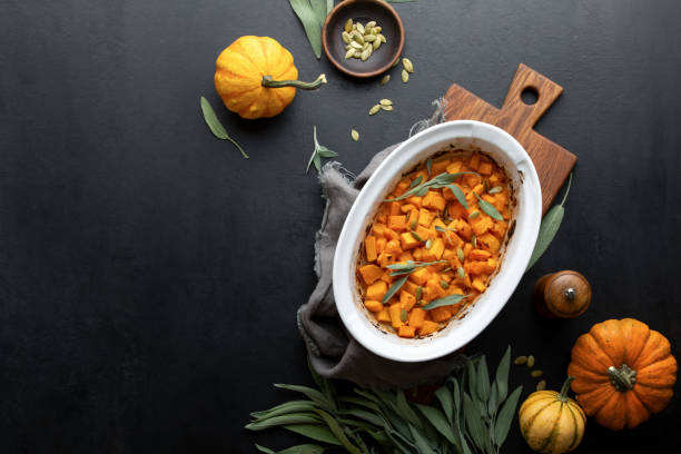 Roasted butternut squash with sage and pumpkin seeds, view from above, blank space for a text