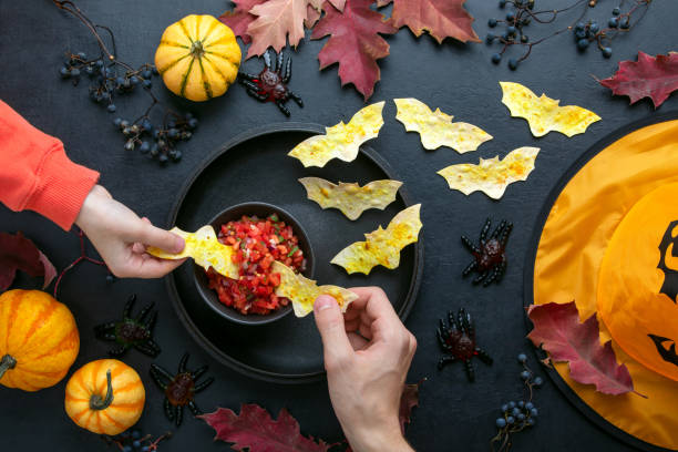 Halloween table setting with red salsa and bat tortillas