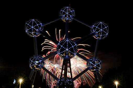 Brussels, Belgium. 26th July 2019. Fireworks explode during 'Laeken Firework Spectacular' in back of the Atomium.