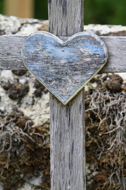 istock Wooden heart on a cross. 1181255020