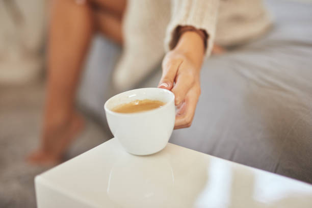 istock Woman putting coffee on night table. 1181255023