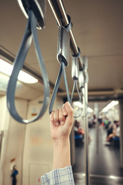 istock People Hand holding Handle on the train. 1181256500