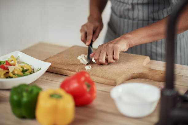 istock Woman cutting mushrooms. 1181256751