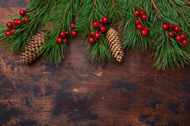 istock Christmas background with fir tree branches and holly. View from above. Copy space 1181257705