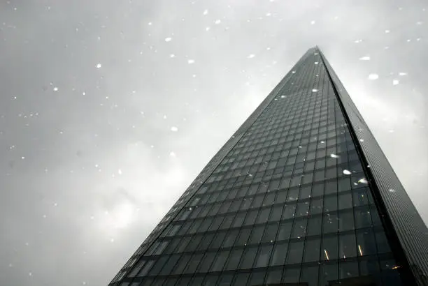 Low angle view of winter weather by London's tallest building with a dramatic sky in the background