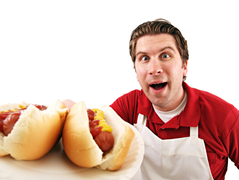 a man serving hot dogs isolated on white.