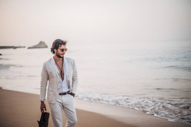istock Young man taking a walk on the beach 1181264806