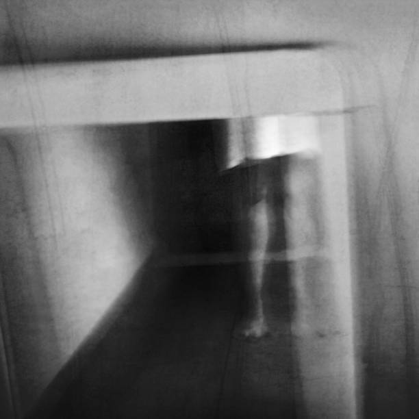 istock A ghost appears in an old vintage mirror. Phantom apparition. 1181264979