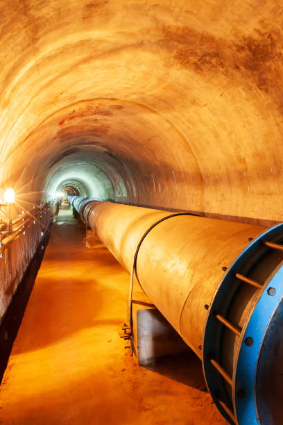 istock Horizontal perspective of water pipe in a mountain tunnel. 1181266197