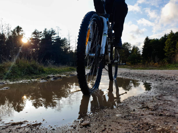 istock Bicycle in a puddle. Bicycle off-road. Off-road bicycle wheel. 1181266307