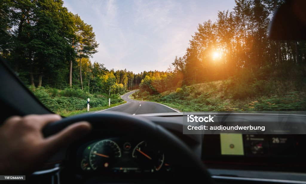 hands of car driver on steering wheel, road trip, driving on highway road Driving Stock Photo