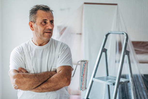 istock Senior painter holding paint roller portrait 1181266737