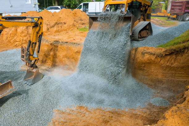 istock Yellow wheel unloading gravel at construction work equipment machinery for construction of foundation 1181267441