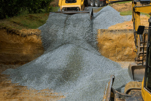 istock Excavator unloading gravel in the construction works of foundation 1181267443