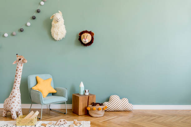 Stylish scandinavian kid room with toys, teddy bear, plush animal toys, mint armchair, umbrella, cotton balls. Modern interior with eucalyptus background walls, Design interior of childroom. Template Stylish scandinavian kid room. Design interior of childroom. Template Home decor concept. kid goat stock pictures, royalty-free photos & images