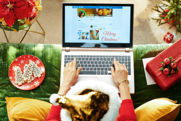 istock female dropping Merry Christmas message in social network 1181272065