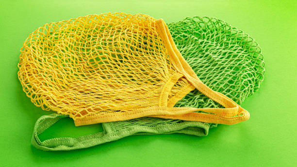 istock Two reusable cotton net bags or mesh bags on coloured background 1181272189