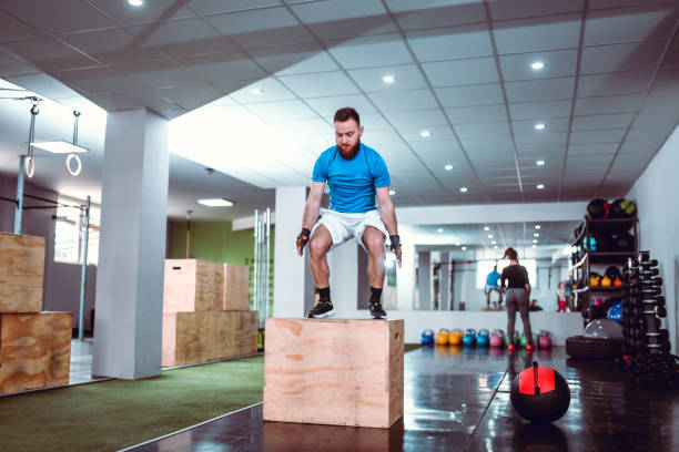 istock Handsome Male Doing Box Jumps In Gym 1181276075
