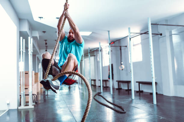 istock Male Climbing Rope In Gym 1181277888