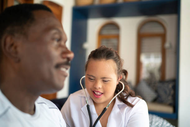 istock Special needs home caregiver examining senior man 1181278515