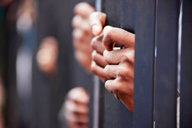 Stolen life Stolen life, group of hands African people behind bars holding them. prison stock pictures, royalty-free photos & images