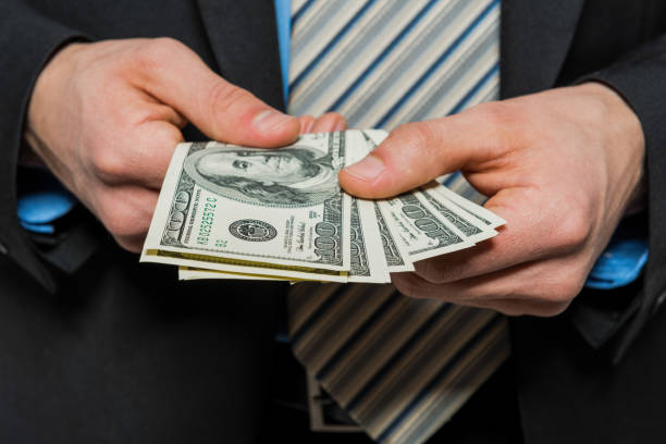 istock Businessman showing money 1181281341