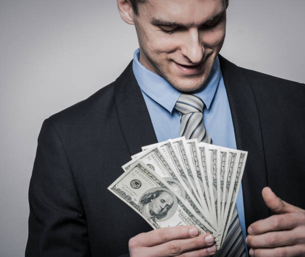 istock Young businessman holding money 1181281420
