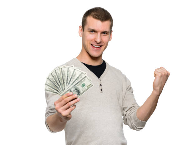 istock Happy student holding money in 100 dollar bills 1181282449