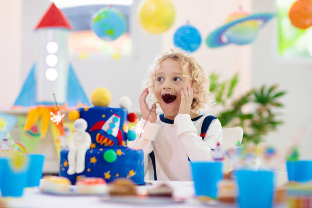 istock Kids space theme birthday party with cake. 1181283772