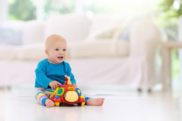 istock Baby boy playing with toy 1181283949