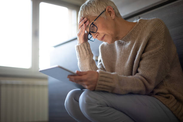 istock Worried senior woman reading an e-mail on tablet 1181284146