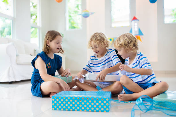 istock Space theme kids birthday party. Boy with present. 1181284226